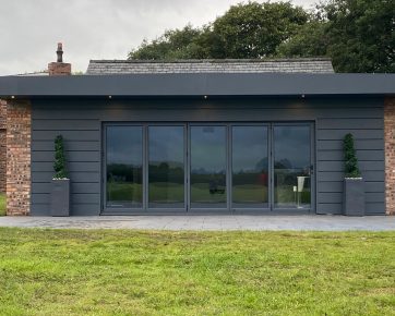 Powder-coated Aluminium cladding panels situated on the wall in matt grey